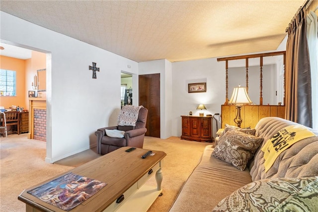 carpeted living room featuring a textured ceiling