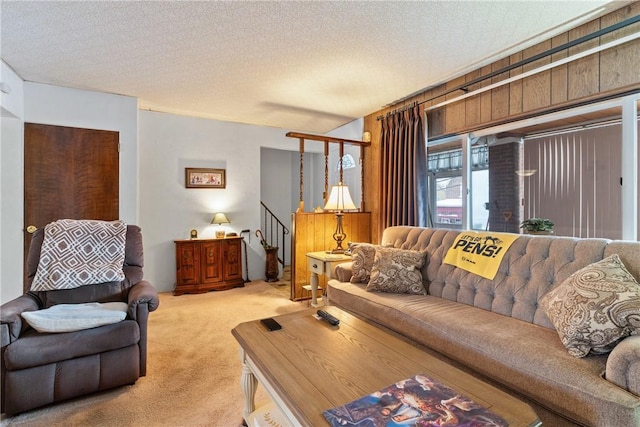 living room featuring light colored carpet and a textured ceiling