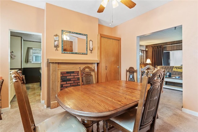 carpeted dining area featuring ceiling fan