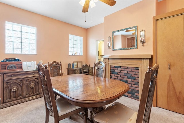 carpeted dining area with ceiling fan and a healthy amount of sunlight