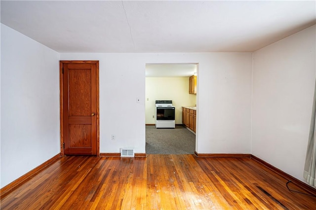 unfurnished room with dark hardwood / wood-style floors