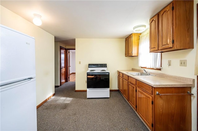 kitchen featuring dark carpet, white appliances, and sink