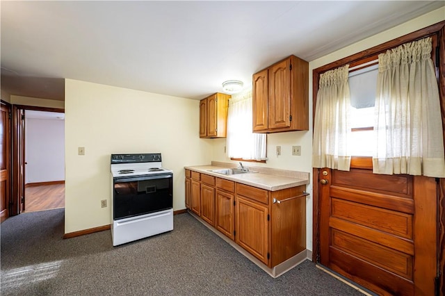 kitchen featuring sink, dark colored carpet, and white range with electric stovetop