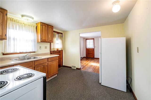 kitchen featuring white appliances and sink