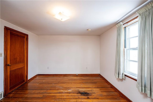 spare room featuring dark hardwood / wood-style floors