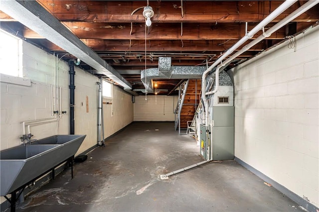 basement with heating unit and sink