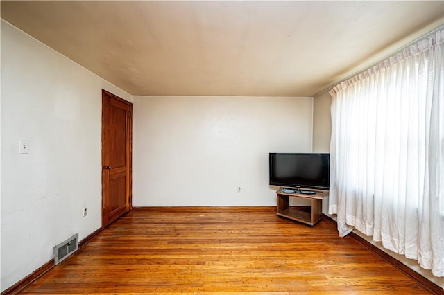 unfurnished living room featuring a healthy amount of sunlight and light hardwood / wood-style floors