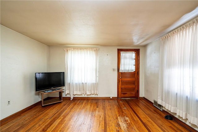 unfurnished living room featuring hardwood / wood-style flooring