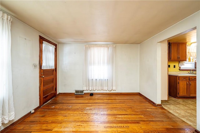 interior space with sink, plenty of natural light, and light hardwood / wood-style floors