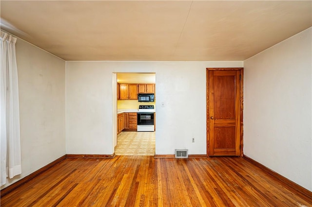 unfurnished room with light hardwood / wood-style floors