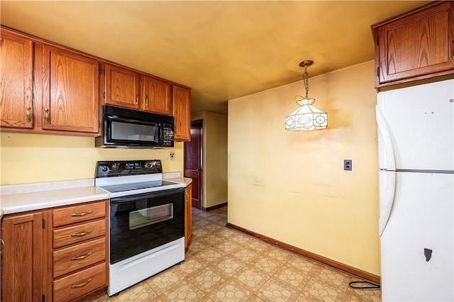 kitchen with white refrigerator, decorative light fixtures, and electric range oven