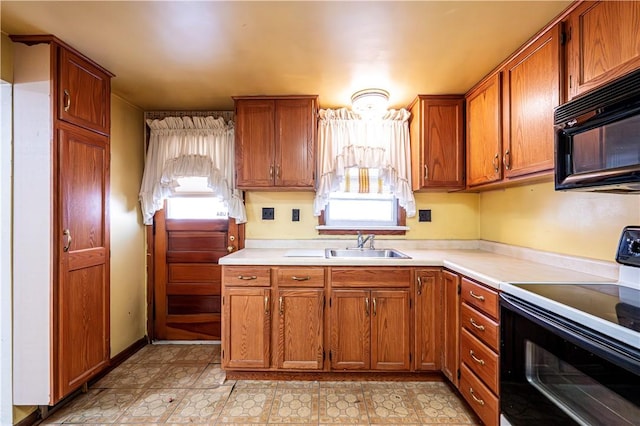 kitchen with plenty of natural light, sink, and electric range