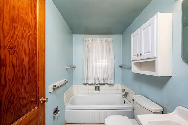 bathroom featuring toilet and a tub