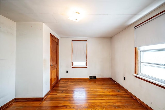 unfurnished room with hardwood / wood-style floors