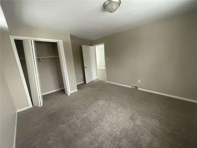 unfurnished bedroom with dark colored carpet