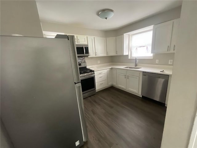 kitchen with stainless steel appliances, dark hardwood / wood-style floors, sink, and white cabinets