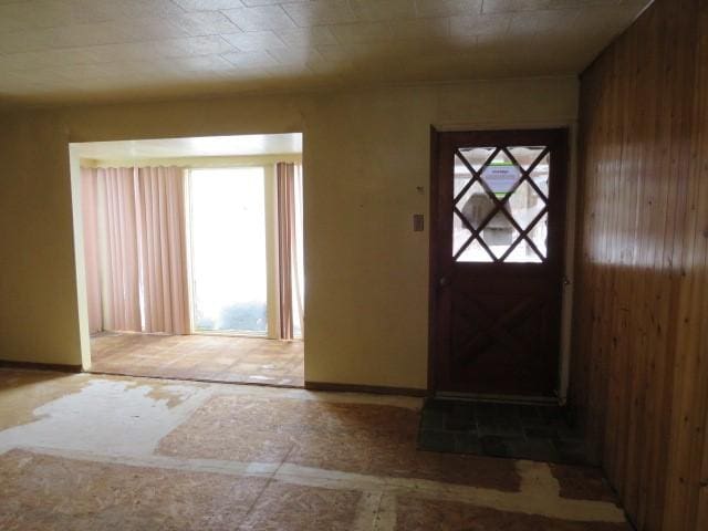 entrance foyer featuring wooden walls