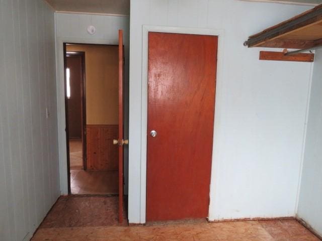 corridor featuring wood walls