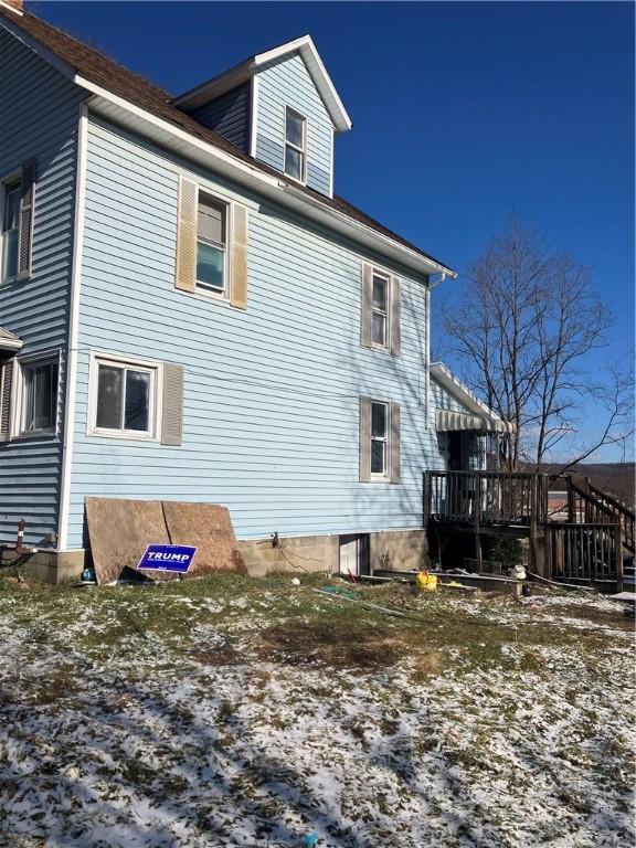 view of home's exterior featuring a wooden deck