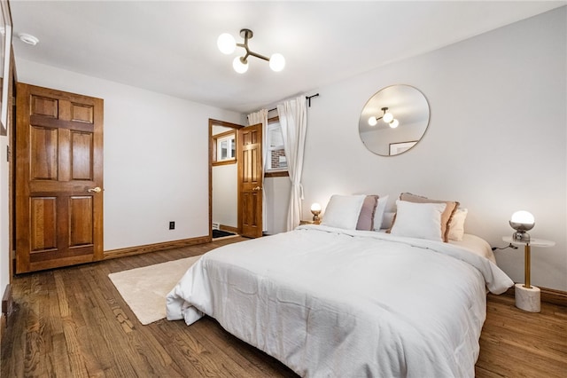 bedroom with dark wood-type flooring