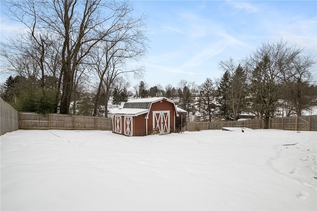 yard layered in snow with a storage unit