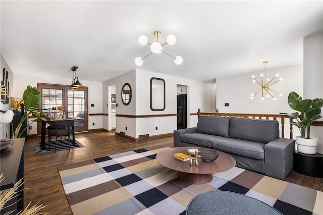 living room featuring a notable chandelier and dark wood-type flooring