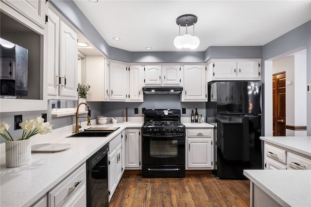 kitchen with sink, white cabinetry, range hood, black appliances, and dark hardwood / wood-style flooring