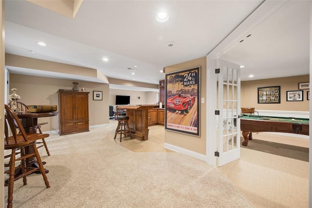 playroom with light colored carpet, bar area, and french doors