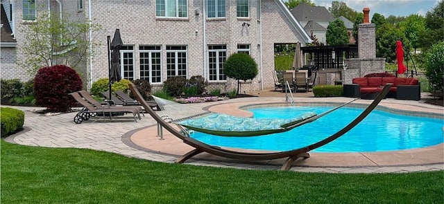 view of swimming pool with a lawn and a patio