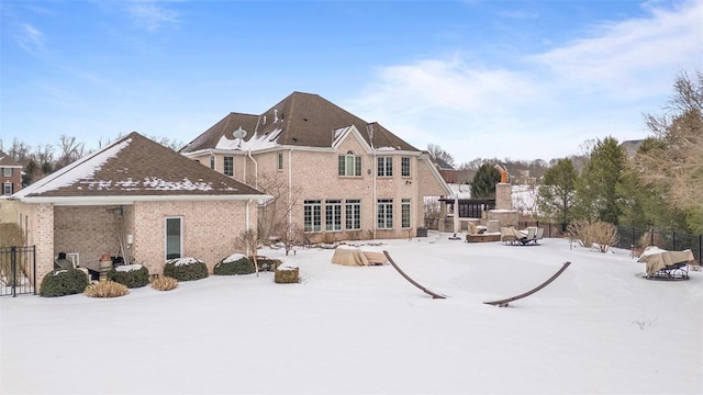 view of snow covered back of property