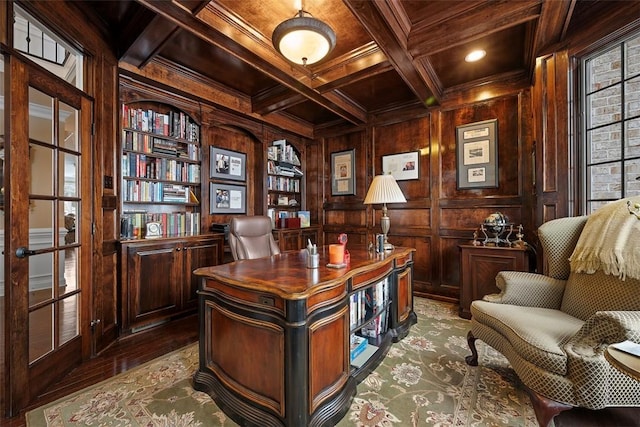 home office with wood walls, beamed ceiling, coffered ceiling, wood ceiling, and built in shelves