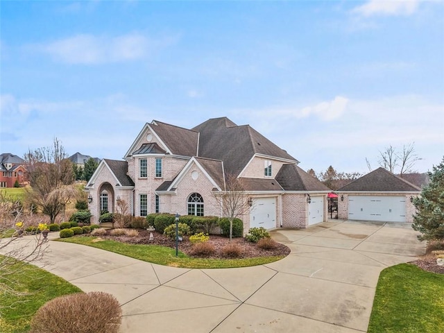 view of front of property with brick siding, driveway, and an attached garage