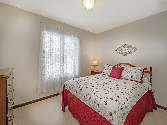 bedroom featuring light colored carpet