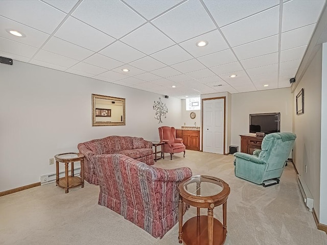 living room with sink, light colored carpet, and baseboard heating