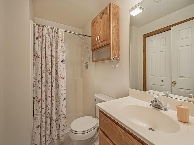 bathroom featuring vanity, curtained shower, and toilet