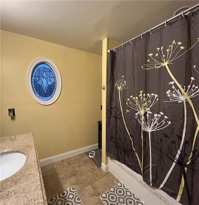 bathroom featuring tile patterned flooring, vanity, and curtained shower