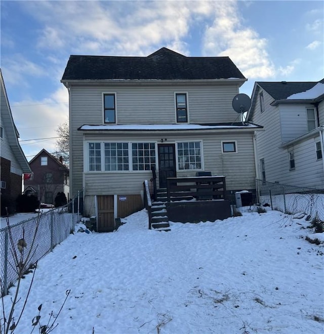 snow covered property with central AC unit