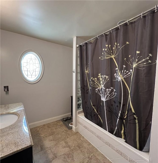 bathroom featuring shower / bath combo and vanity