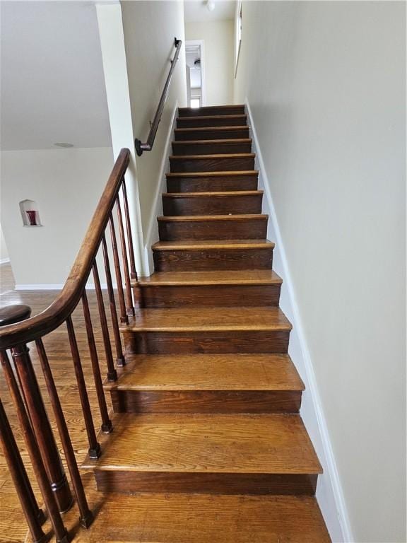 stairs with hardwood / wood-style floors