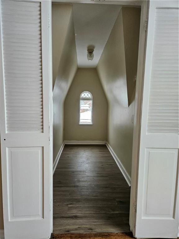 bonus room with vaulted ceiling and dark hardwood / wood-style flooring