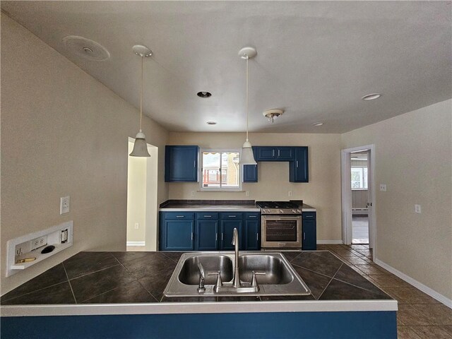1732 Pennsylvania Ave, West Mifflin, PA 15122 - kitchen with stainless steel gas range, blue cabinetry, a sink, a peninsula, and decorative light fixtures
