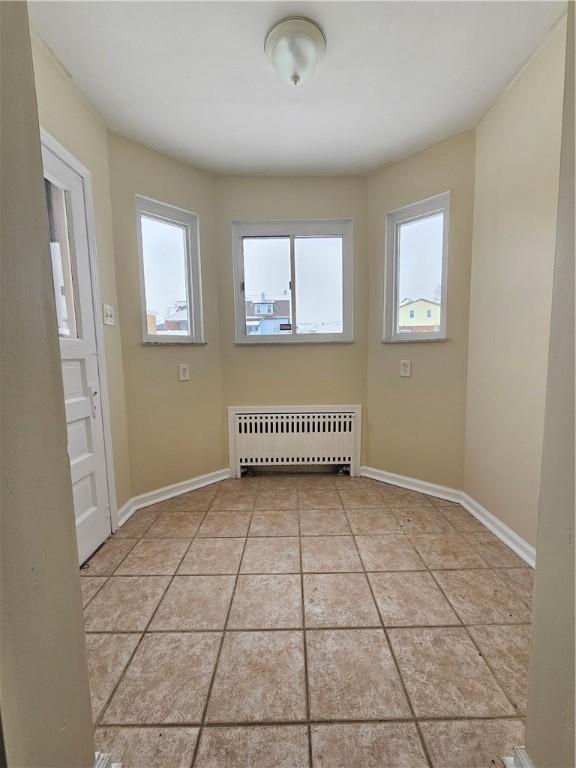 1732 Pennsylvania Ave, West Mifflin, PA 15122 - empty room with radiator heating unit, healthy amount of natural light, and baseboards