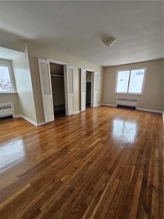 1732 Pennsylvania Ave, West Mifflin, PA 15122 - unfurnished living room featuring radiator heating unit, dark wood-style flooring, and baseboards