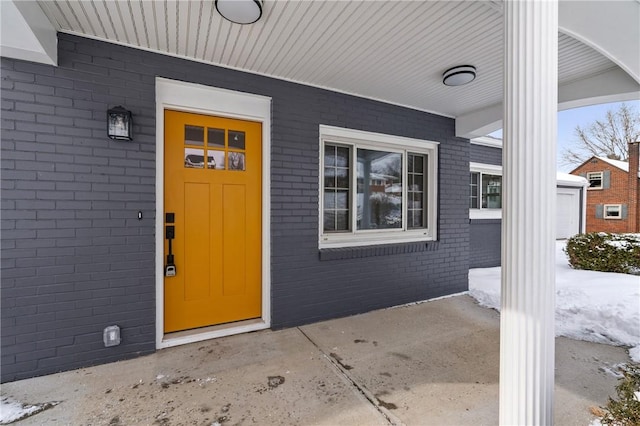 view of exterior entry featuring a porch