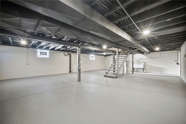 basement featuring water heater and sink