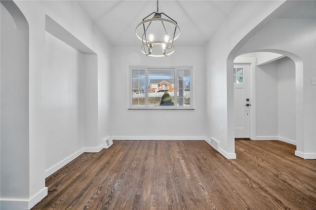 interior space featuring dark hardwood / wood-style flooring and a notable chandelier