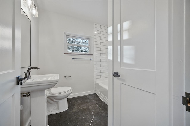 full bathroom with tiled shower / bath, sink, and toilet