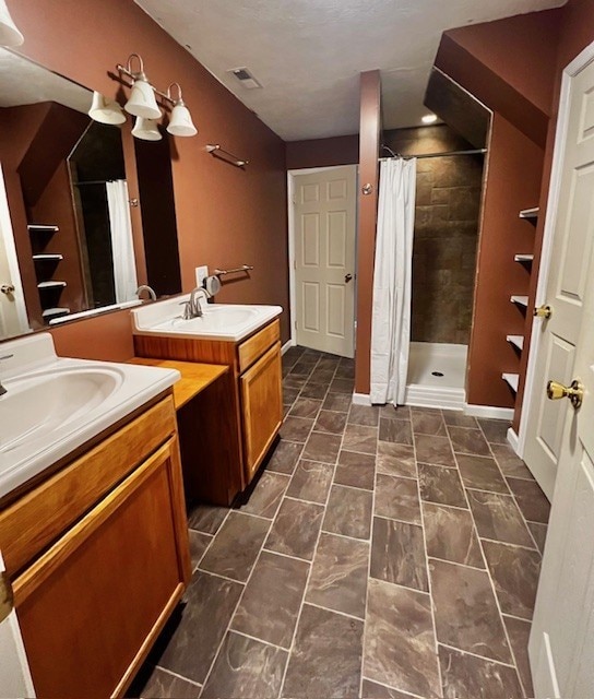 bathroom featuring a shower with curtain and vanity