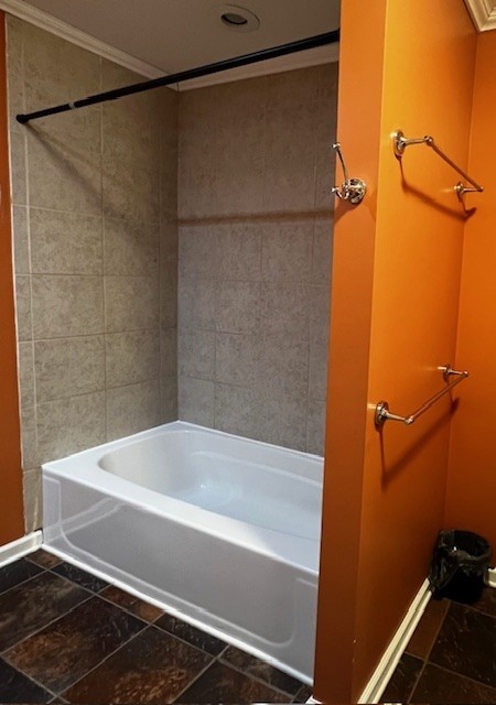 bathroom featuring crown molding and bathtub / shower combination