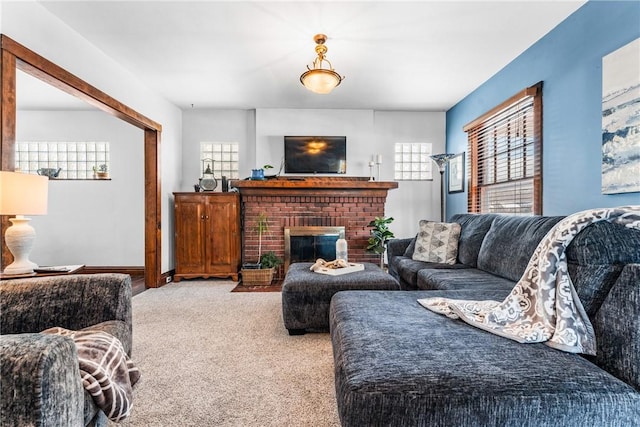 living room with carpet floors and a fireplace